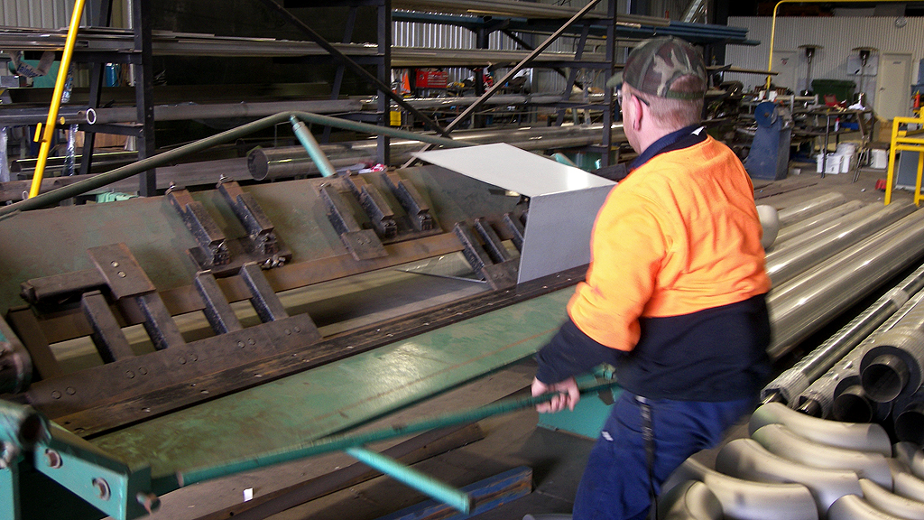 Man holding a pipe in welding services